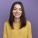 smiling young pretty caucasian girl looking at camera isolated on purple background with copy space