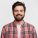 Smiling bearded young male model rejoices coming weekends, dressed casually, isolated over white background. Positive pleased student being in good mood after successfully passed exams at college